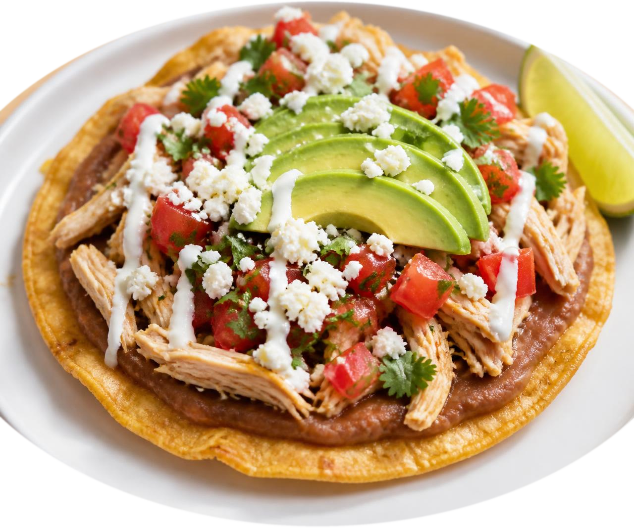 A crisp golden corn Flat Taco shell spread with refried beans and loaded with shredded chicken, avocado, fresh salsa, crumbled cheese, crema and cilantro.